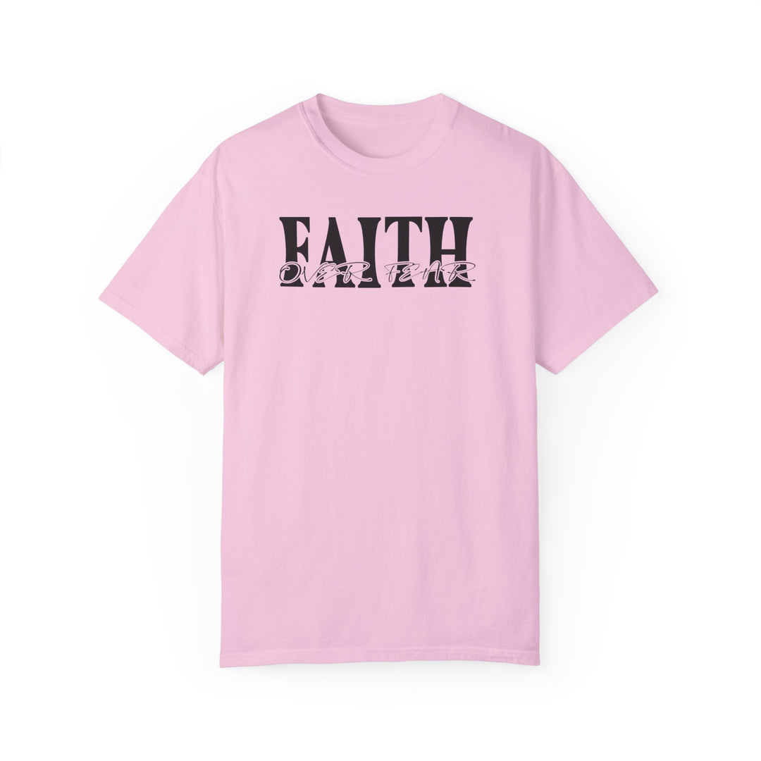 A Faith Over Fear Tee, a pink t-shirt with black text, made of 100% ring-spun cotton. Garment-dyed for extra coziness, featuring a relaxed fit and durable double-needle stitching. From Worlds Worst Tees.