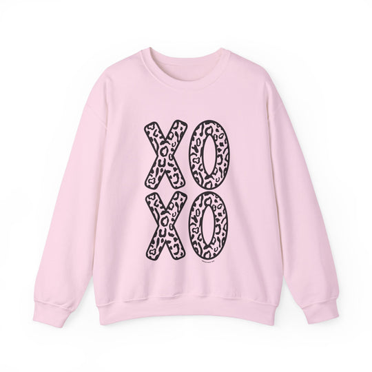Unisex XOXO Crew sweatshirt with pink leopard print and black letters. Cotton-polyester blend, ribbed knit collar, loose fit, medium-heavy fabric. Ideal for comfort and style.