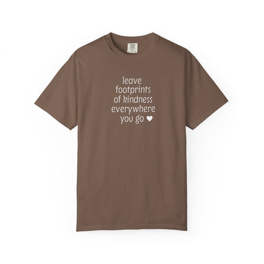 Leave Kindness Tee: Chocolate brown crew-neck T-shirt featuring the phrase “leave footprints of kindness everywhere you go ♥” in white, stacked lettering. Relaxed fit, soft-washed, durable.