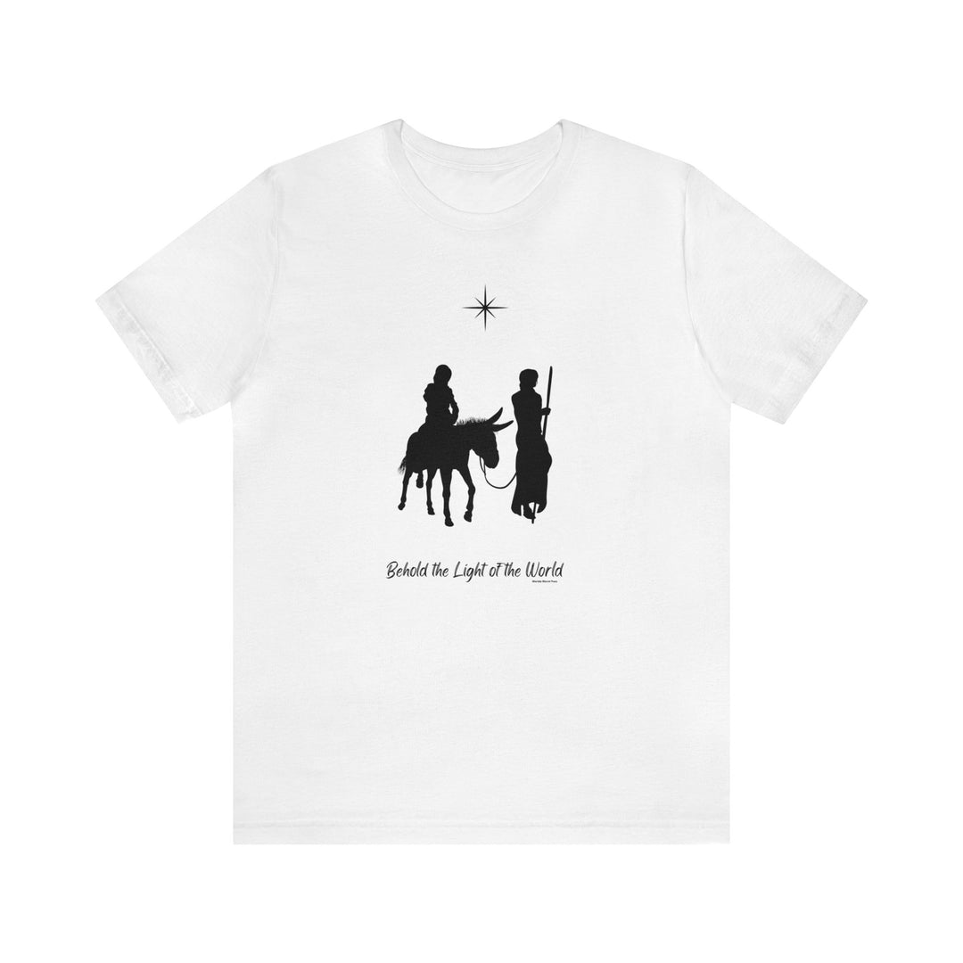Unisex white tee featuring black silhouettes of men riding a donkey and a star. Soft 100% cotton, retail fit, ribbed collar, and taped shoulders for lasting comfort. Behold the Light of the World Tee.
