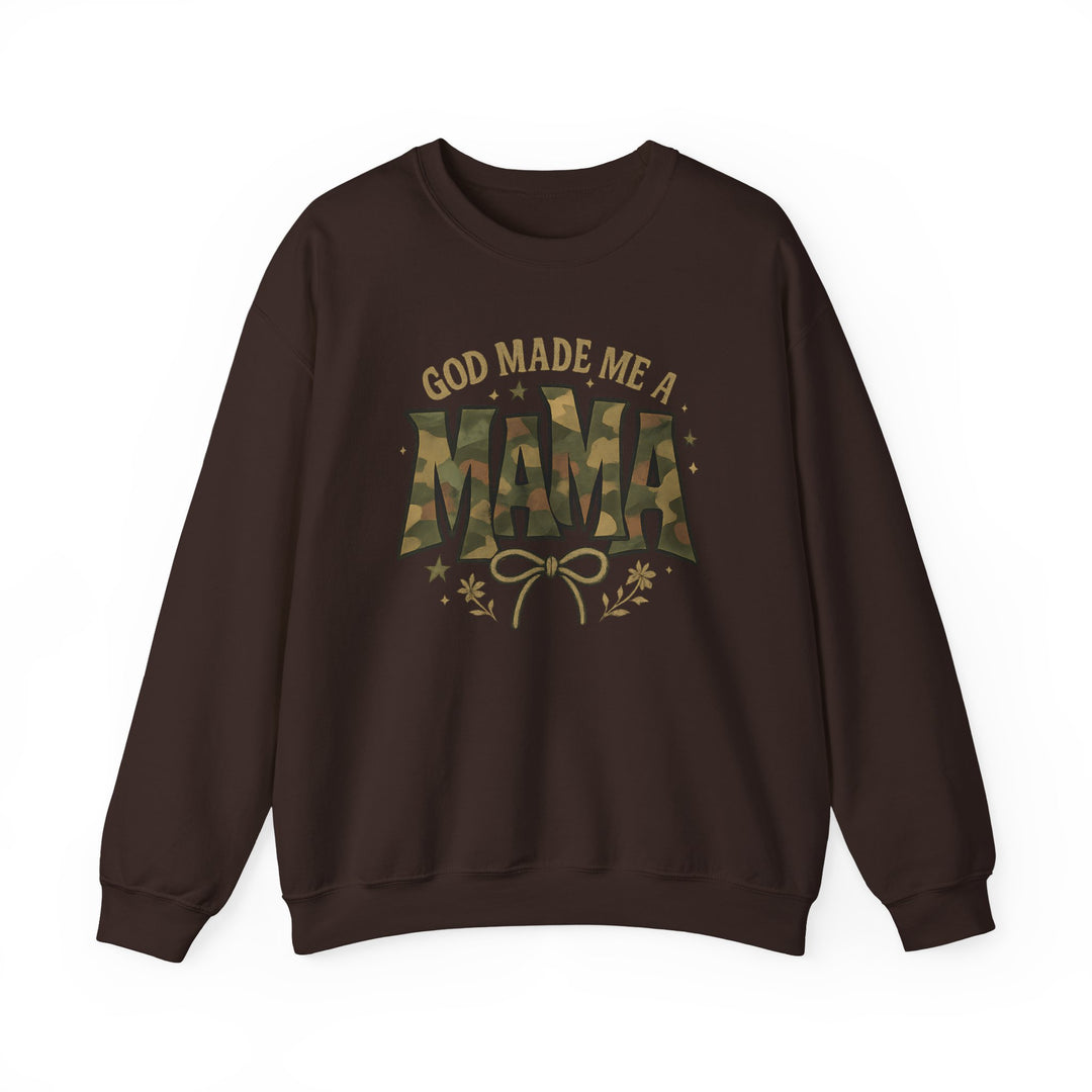 Dark-brown crewneck sweatshirt reads “GOD MADE ME A MAMA” with camouflage “MAMA,” featuring a bow and floral accents, offering cozy, durable comfort.