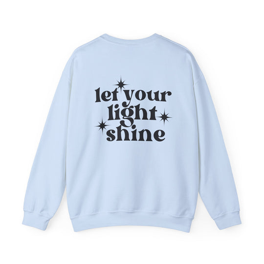 A white crewneck sweatshirt with black text, featuring the Let Your Light Shine Crew design. Unisex, heavy blend fabric for comfort, ribbed knit collar, and no itchy side seams. Sizes range from S to 5XL.