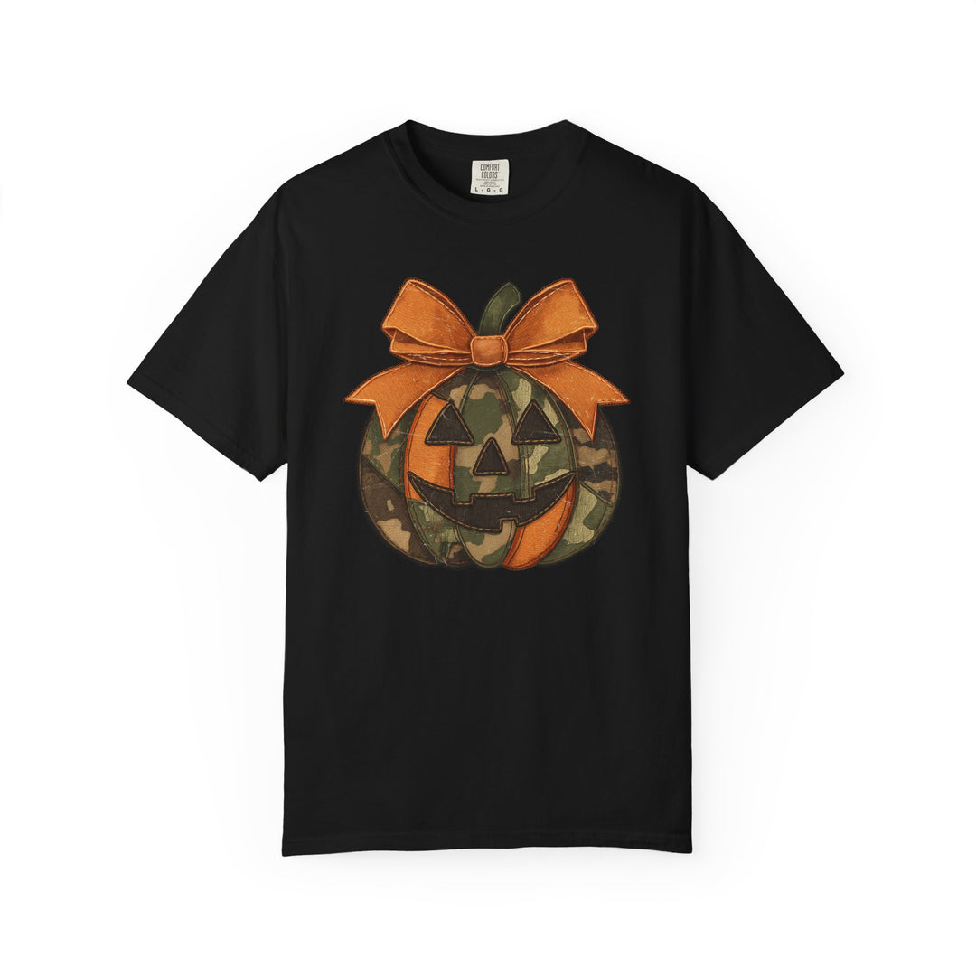 Jackie O Tee: Black short-sleeve shirt featuring a camouflage and orange jack-o-lantern graphic with an orange bow, highlighting unique graphic design from Worlds Worst Tees.