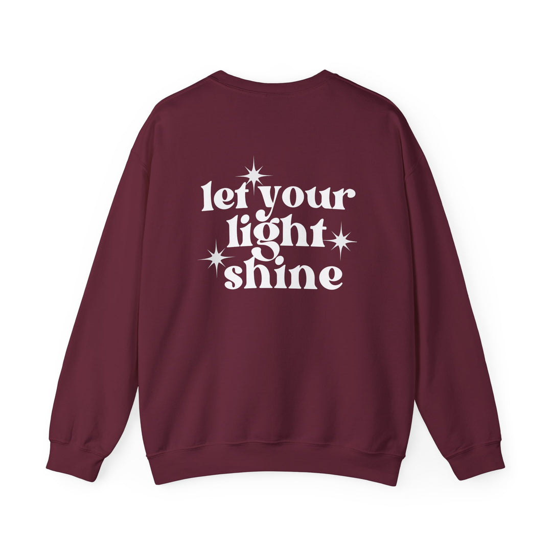 Unisex heavy blend crewneck sweatshirt, Let Your Light Shine Crew, in maroon. Features ribbed knit collar, no itchy side seams, 50% cotton 50% polyester, loose fit, medium-heavy fabric. Ideal for comfort and style.