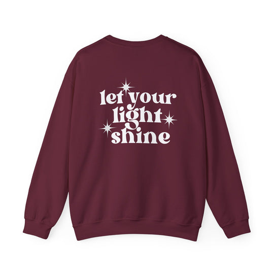 Unisex heavy blend crewneck sweatshirt, Let Your Light Shine Crew, in maroon. Features ribbed knit collar, no itchy side seams, 50% cotton 50% polyester, loose fit, medium-heavy fabric. Ideal for comfort and style.