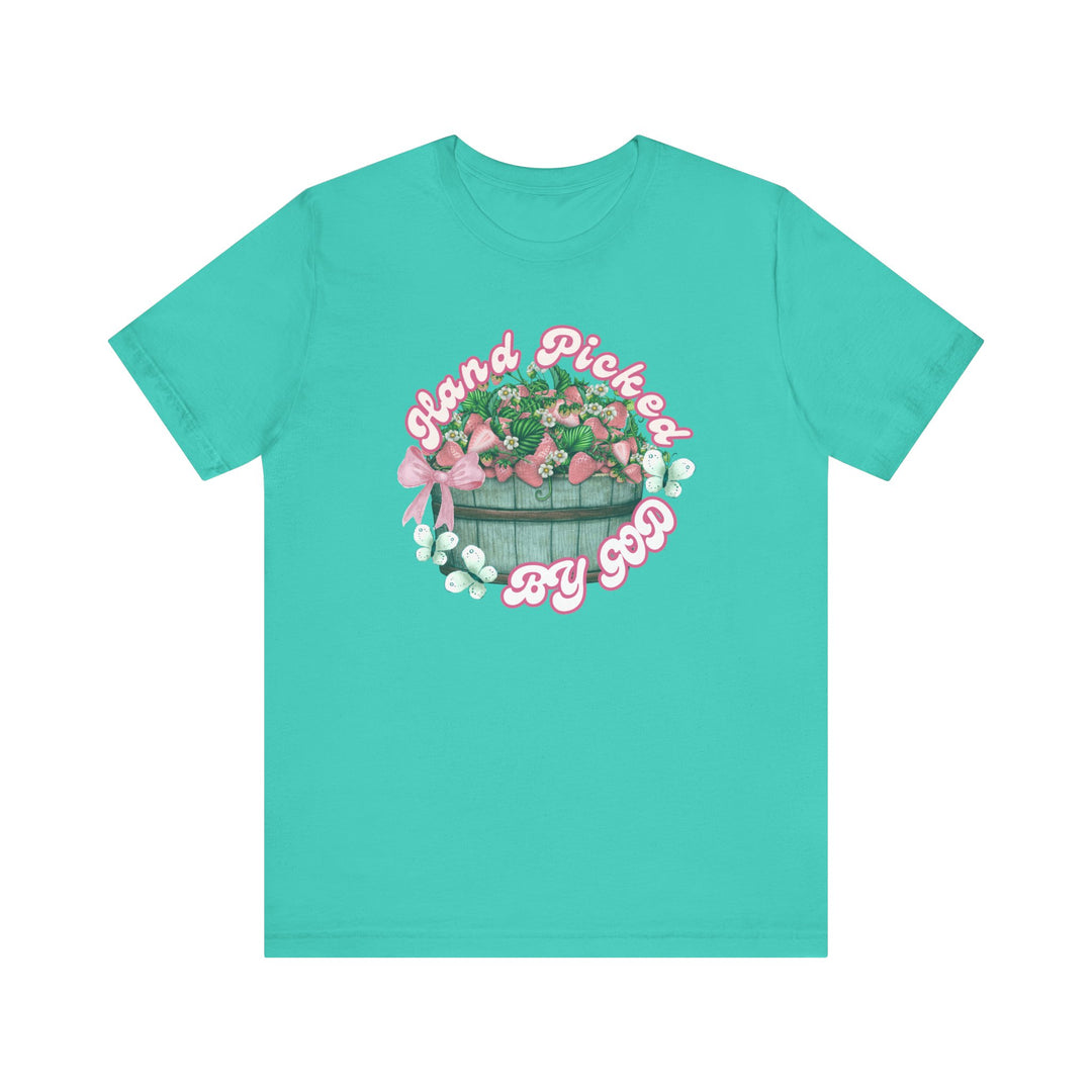 Classic unisex 'Hand Picked by GOD' tee, showcasing a soft cotton jersey with ribbed collar, tapered shoulders, and dual side seams for durability.