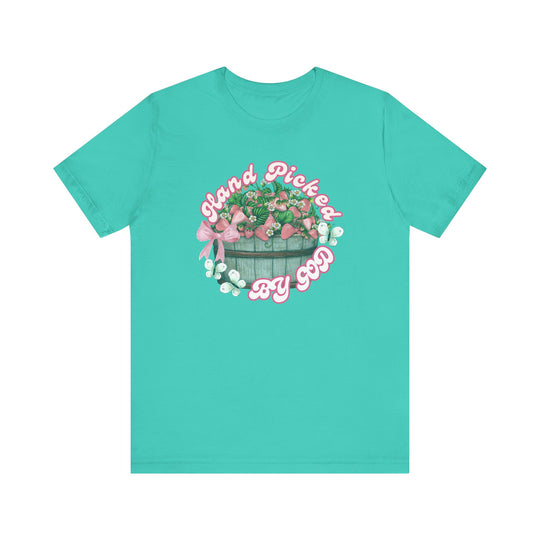 Classic unisex 'Hand Picked by GOD' tee, showcasing a soft cotton jersey with ribbed collar, tapered shoulders, and dual side seams for durability.