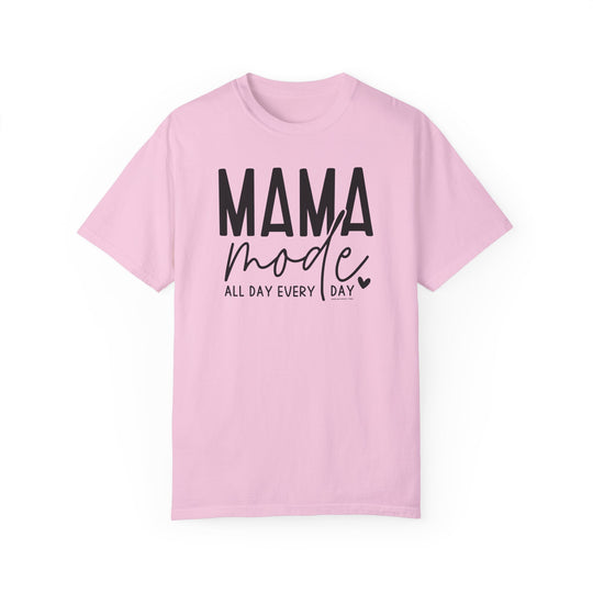 A Mama Mode Tee, a pink shirt with black text, made of 100% ring-spun cotton. Garment-dyed for extra coziness, featuring a relaxed fit, double-needle stitching, and no side-seams for durability and shape retention.