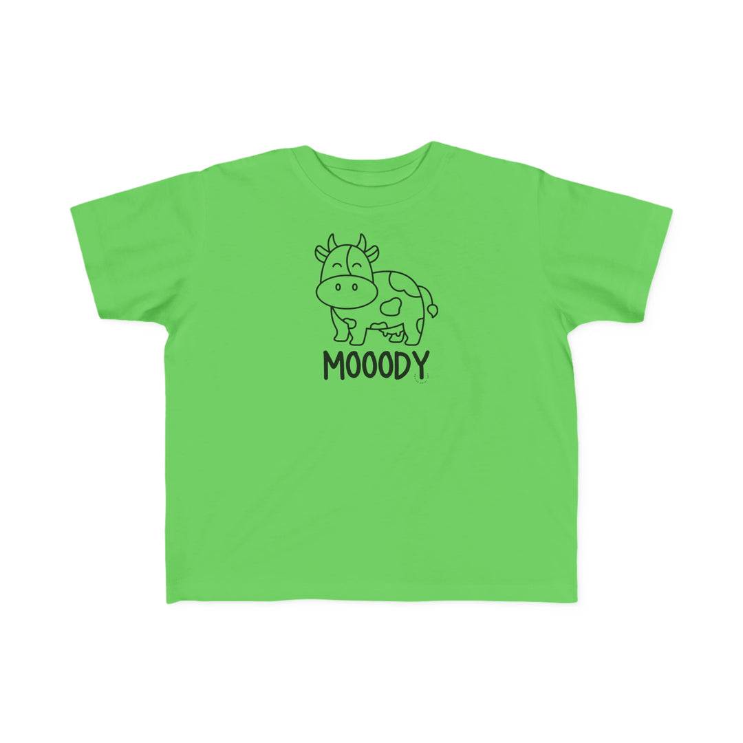 Moody Toddler Tee: A green shirt featuring a cow, perfect for sensitive toddler skin. Made of 100% combed ringspun cotton, light fabric, classic fit, and tear-away label. Ideal for first adventures.