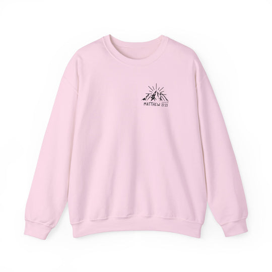 A pink Faith Can Move Mountains Crew sweatshirt featuring a logo of a mountain with sun rays. Unisex heavy blend crewneck made of 50% cotton and 50% polyester for comfort and durability. Sizes from S to 5XL.