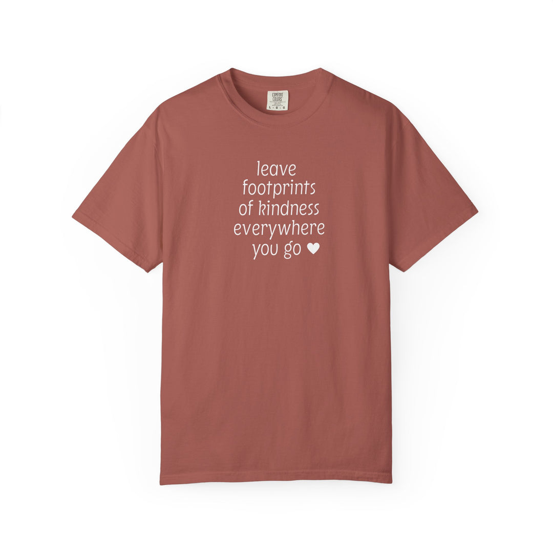 Leave Kindness Tee in terra-cotta with white text saying leave footprints of kindness everywhere you go ♥, featuring a relaxed fit and durable stitching.