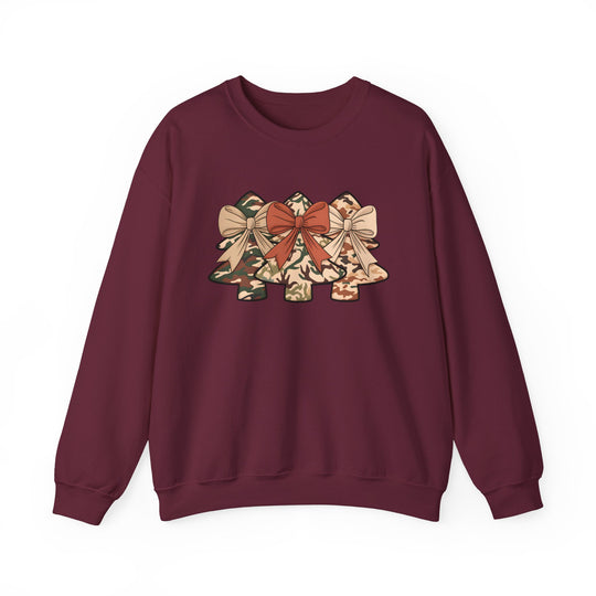 Maroon crewneck sweatshirt featuring three camouflage-patterned Christmas trees with bows, offering comfort in a cotton-polyester blend. Ideal for festive, casual wear.