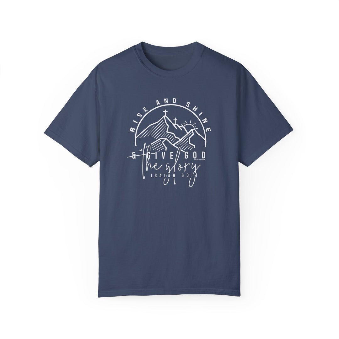 A relaxed fit Rise and Shine Tee in blue with white text and a cross graphic. 100% ring-spun cotton, garment-dyed for coziness. Durable double-needle stitching, no side-seams for shape retention.