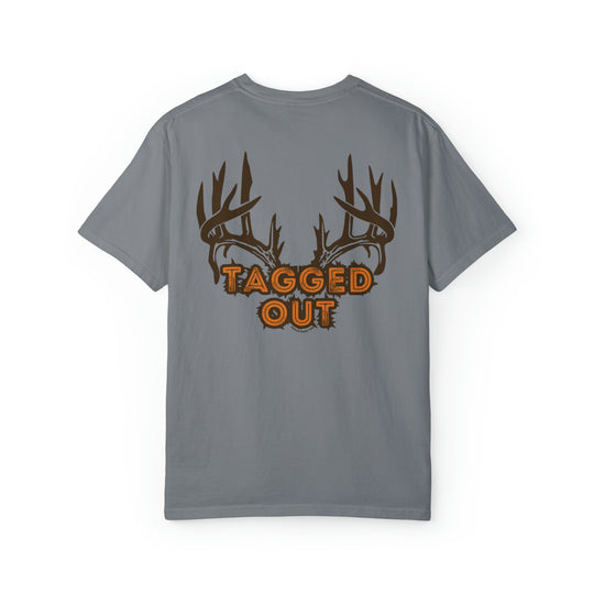 A grey t-shirt featuring antlers and orange text, embodying the Tagged Out Tee style from Worlds Worst Tees. Unisex, relaxed fit, 80% ring-spun cotton, 20% polyester, medium-heavy fabric.