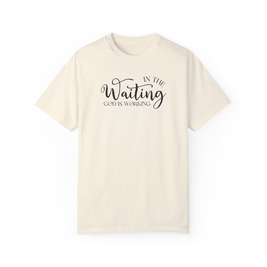 Relaxed fit God is Working Tee, white t-shirt with black text. 100% ring-spun cotton, medium weight, durable double-needle stitching, no side-seams for a tubular shape.
