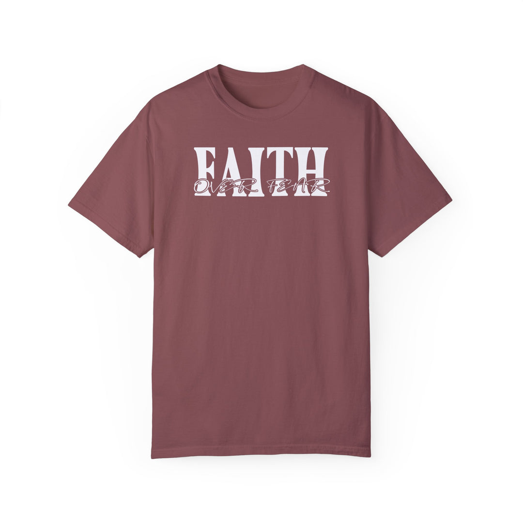 A maroon Faith Over Fear Tee, 100% ring-spun cotton, garment-dyed for coziness. Relaxed fit, double-needle stitching for durability, tubular shape. From Worlds Worst Tees.