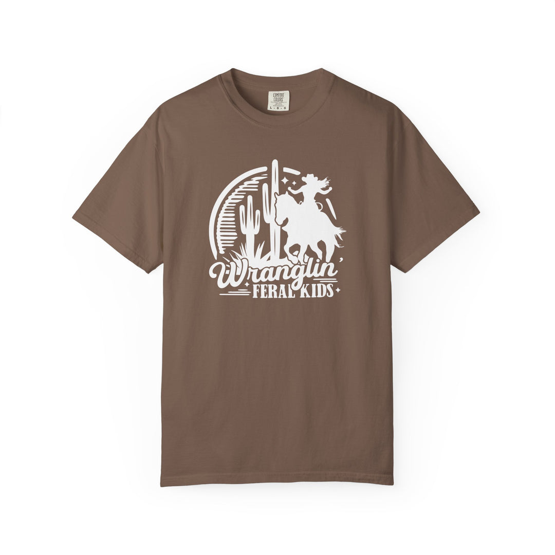 Wranglin’ Feral Kids Tee features a vintage-style graphic of a horseback rider in a desert scene with cacti and a sun, offering a relaxed fit.