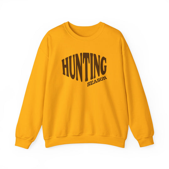 Golden-yellow crewneck sweatshirt featuring HUNTING SEASON in brown text, crafted for comfort with a durable cotton-polyester blend, ideal for cooler weather.