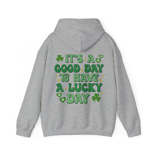 Good Day Lucky Day Hoodie: Grey sweatshirt with green text, featuring a cozy kangaroo pocket and matching drawstring, ideal for casual, warm wear.