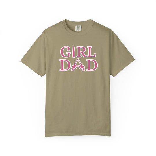 Girl Dad Tee: A tan t-shirt featuring pink text, crafted from soft-washed, 100% ring-spun cotton, offering a relaxed fit and durable double-needle stitching.