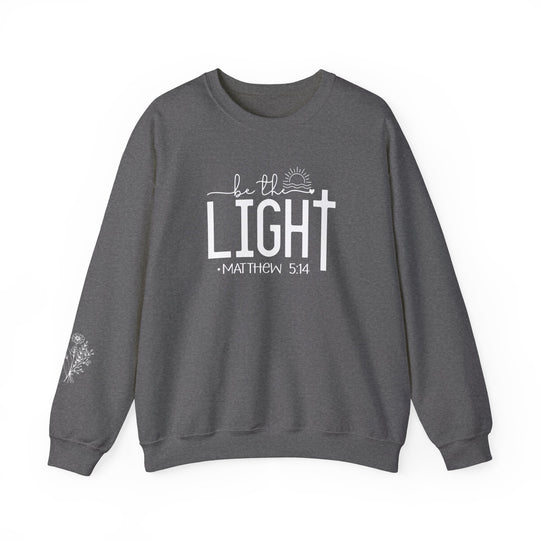 Unisex heavy blend crewneck sweatshirt, Be the Light Crew, in gray with white text. Medium-heavy fabric blend of cotton and polyester for comfort and durability. Ethically made with ribbed knit collar and double-needle stitching.