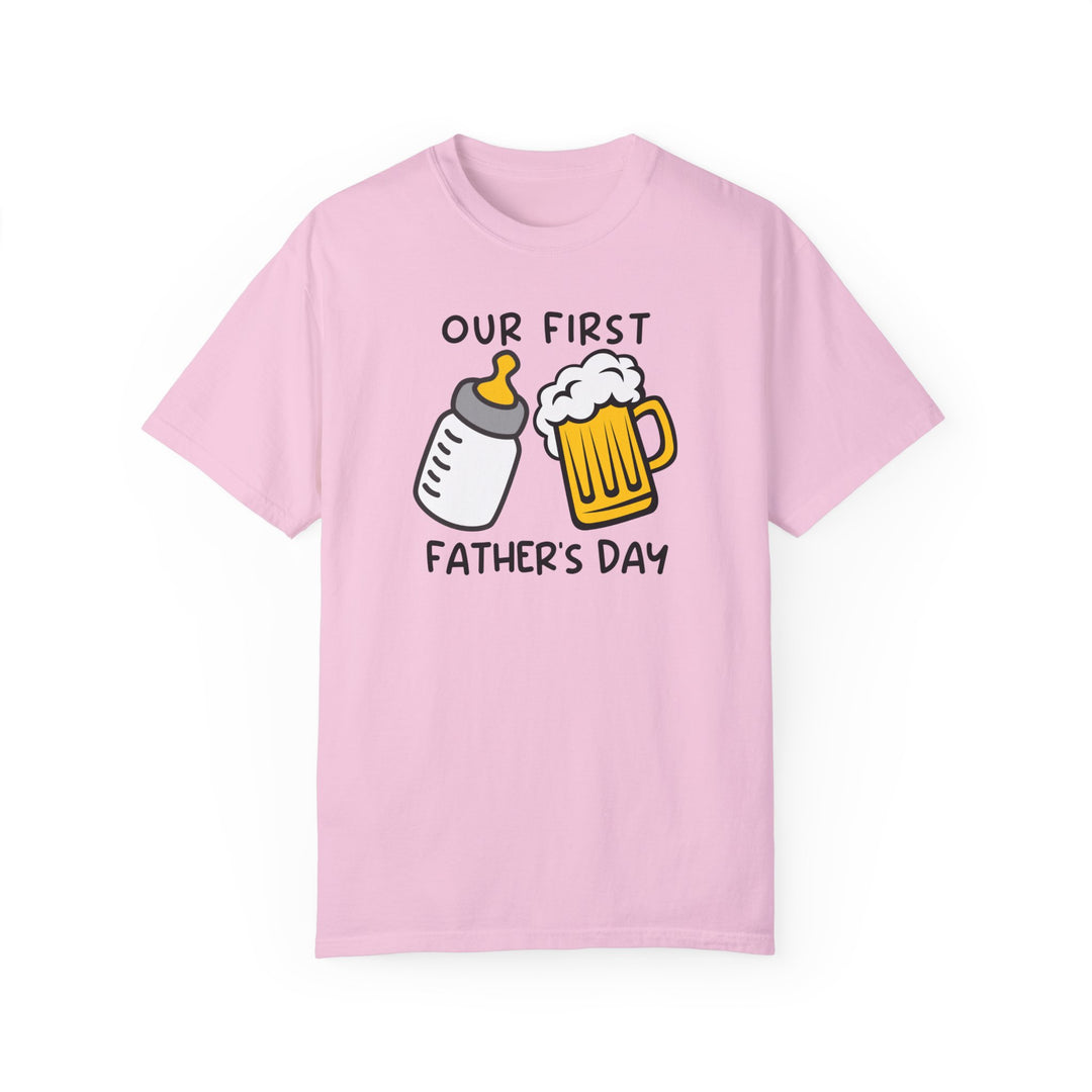 A relaxed fit Our First Father's Day Tee in pink, featuring a graphic design. Made of 100% ring-spun cotton for softness and durability. Ideal for daily wear.