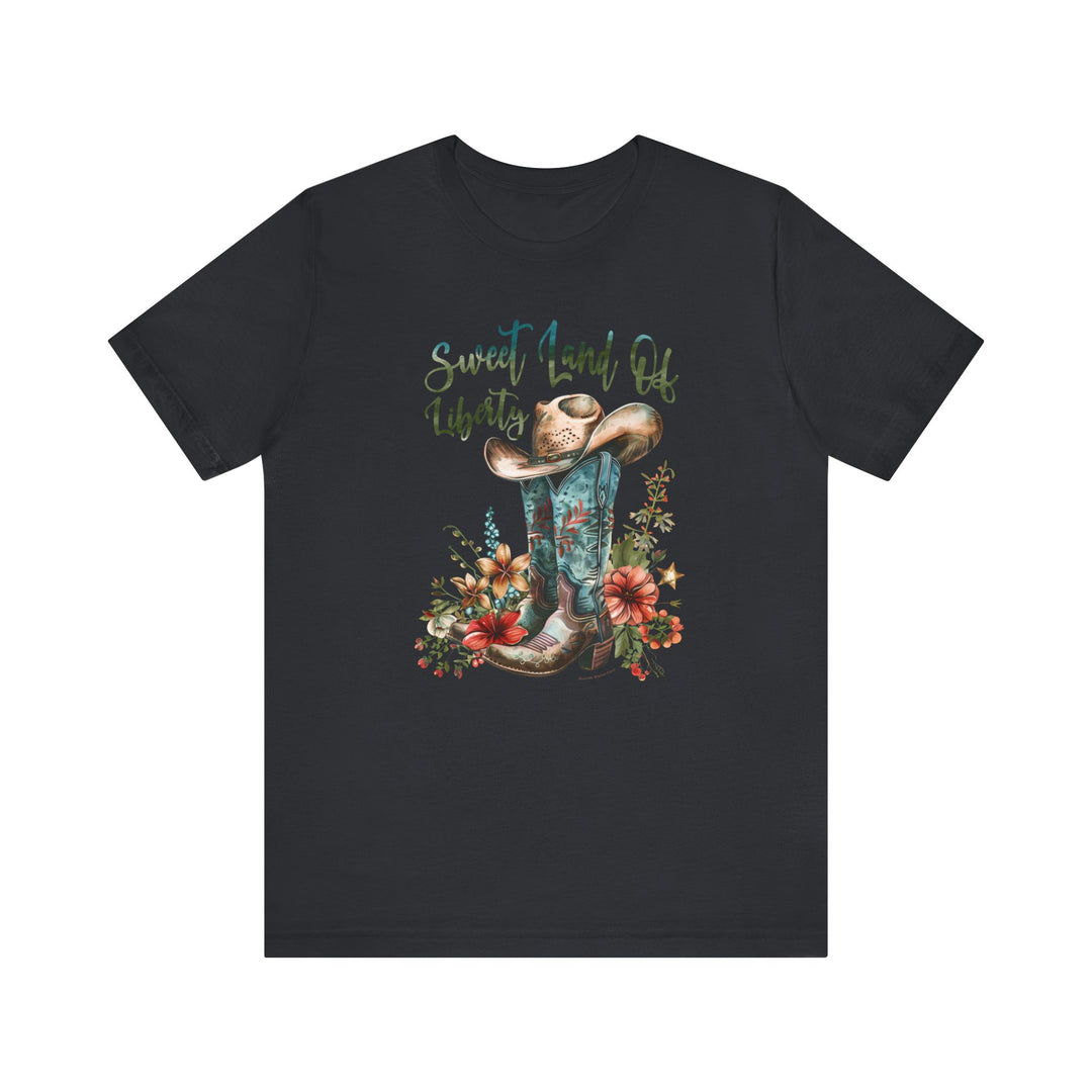 A black tee featuring a cowboy hat and flowers, embodying a classic Americana vibe. Unisex jersey tee made of 100% Airlume combed cotton, with ribbed knit collars and taping for durability. Sweet Land of Liberty Tee by Worlds Worst Tees.