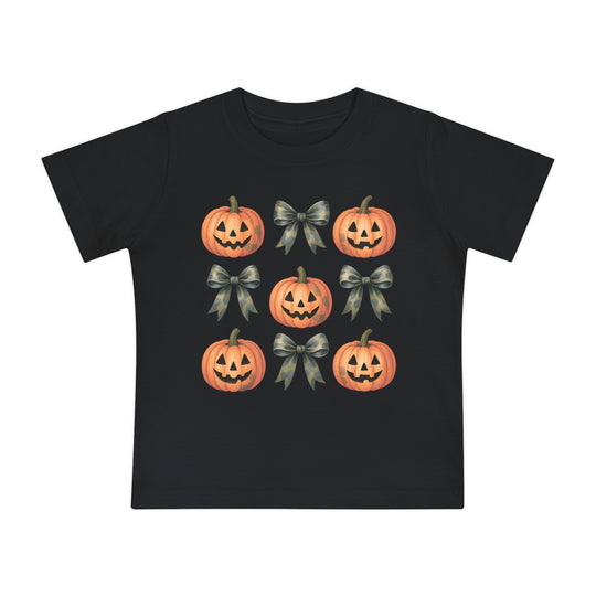 Pumpkins and Bows Baby Tee featuring a 3x3 pattern of jack-o’-lanterns and camo-style bows on a black T-shirt, offering style and comfort for little ones.
