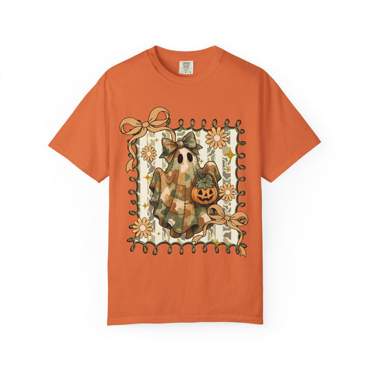Quilted Ghost Tee: Halloween-themed orange T-shirt featuring a ghost in patchwork with bows, jack-o’-lantern, framed by green ribbon and daisy-like flowers.