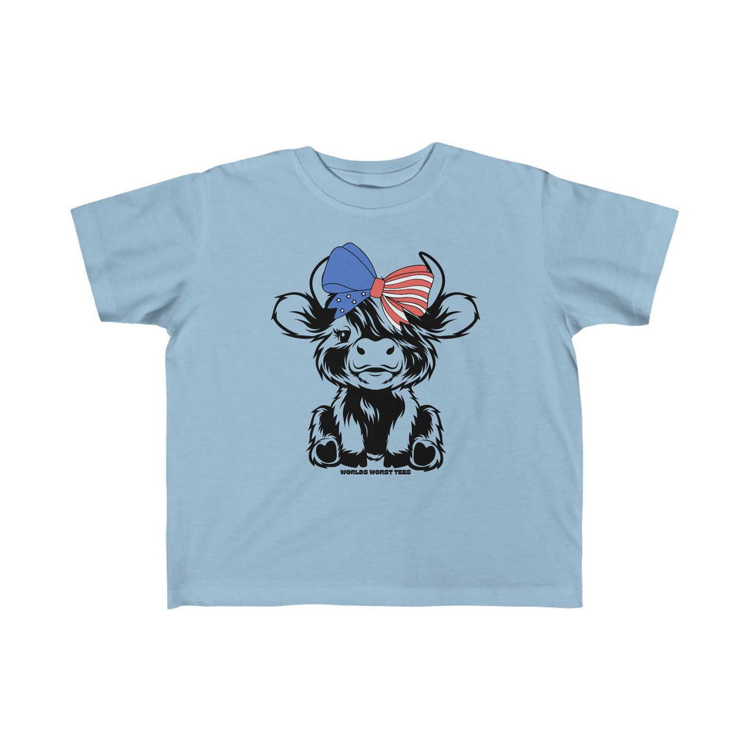 A blue toddler tee featuring a cow with a bow, ideal for sensitive skin. Made of 100% combed ringspun cotton, light fabric, tear-away label, and a classic fit. Perfect for first adventures.