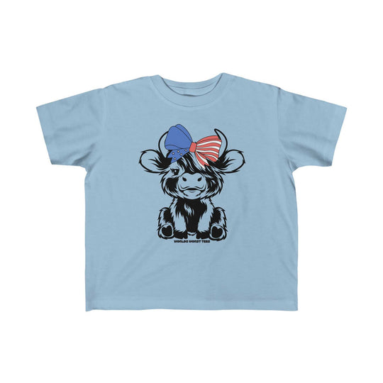 A blue toddler tee featuring a cow with a bow, ideal for sensitive skin. Made of 100% combed ringspun cotton, light fabric, tear-away label, and a classic fit. Perfect for first adventures.
