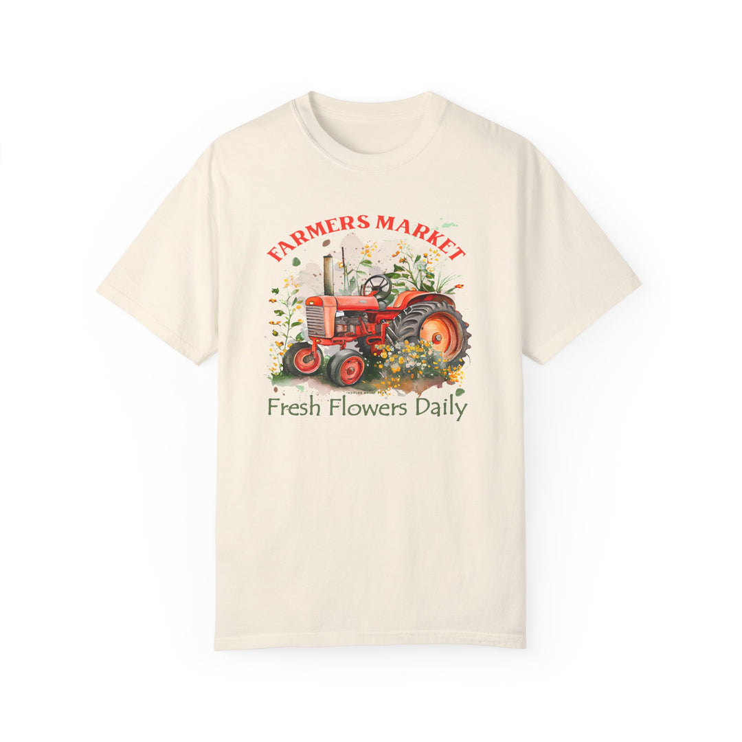 Alt text: Fresh Flowers Tee: A white t-shirt featuring a tractor and flowers design, made of 100% ring-spun cotton for comfort and durability. Relaxed fit with double-needle stitching, ideal for daily wear.