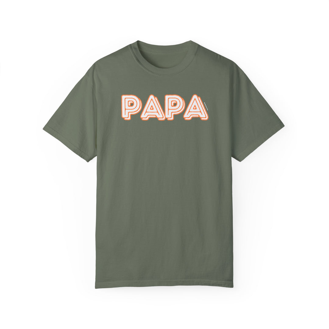A relaxed fit Papa Tee crafted from 100% ring-spun cotton, featuring a white and orange logo on a green shirt. Durable double-needle stitching and seamless design for lasting comfort from Worlds Worst Tees.