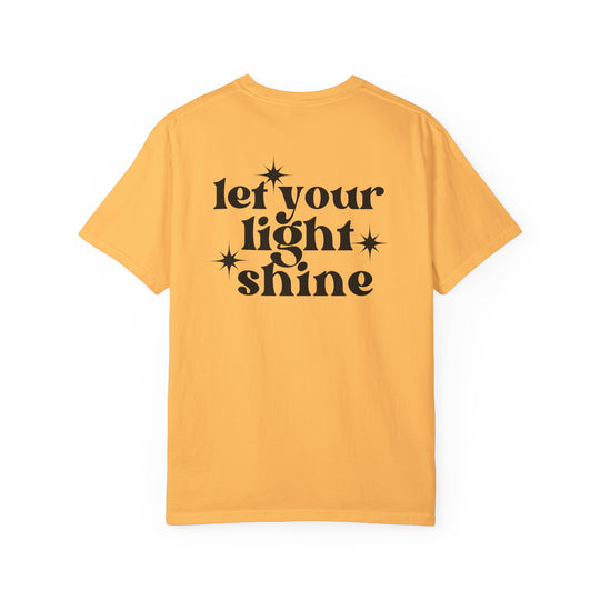 Relaxed fit Let Your Light Shine Tee, a yellow shirt with black text. 100% ring-spun cotton, garment-dyed for coziness. Durable double-needle stitching, no side-seams for shape retention. Sizes: S-3XL.