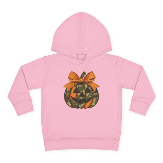 Light-pink Jackie O Toddler Hoodie with camouflage jack-o’-lantern design and orange bow, featuring a durable, cozy construction with side-seam pockets for toddlers.