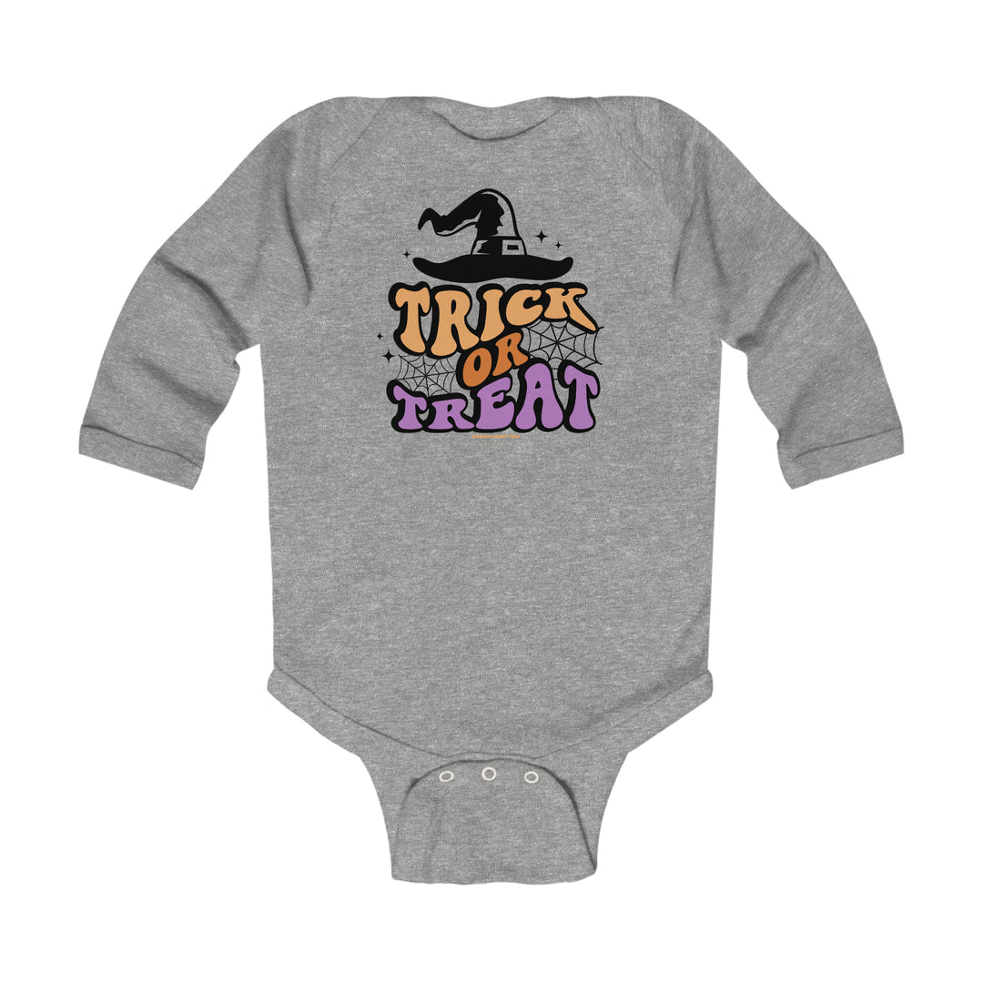 A baby bodysuit featuring a person hat and text, designed for durability and comfort. Long sleeve with plastic snaps for easy changing. Made of 100% combed ring-spun cotton. TRICK OR TREAT LONGSLEEVE ONESIE.