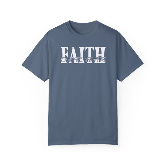 A Faith Over Fear Tee, a garment-dyed t-shirt in blue with white text. Made of 100% ring-spun cotton for coziness, featuring a relaxed fit and durable double-needle stitching. Ideal for daily wear.