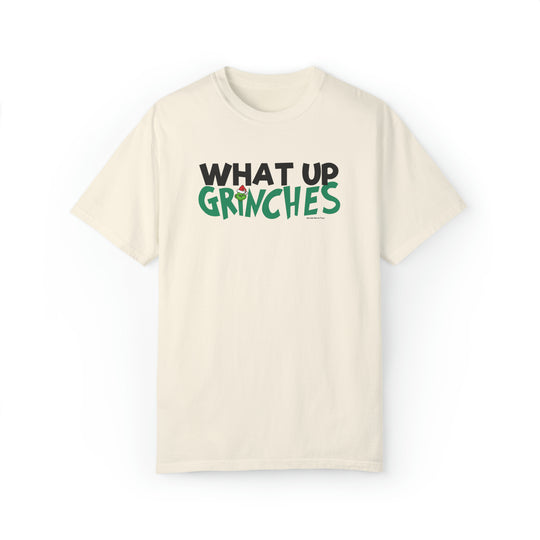 Unisex white t-shirt with green and black 'What up Grinches' text. Made of 80% ring-spun cotton and 20% polyester. Relaxed fit, rolled-forward shoulder, and back neck patch. From Worlds Worst Tees.