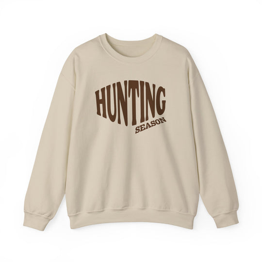 Cream crewneck sweatshirt with “HUNTING SEASON” in brown block font, combining comfort and style with durable, ethically-sourced materials. Perfect for cooler weather.
