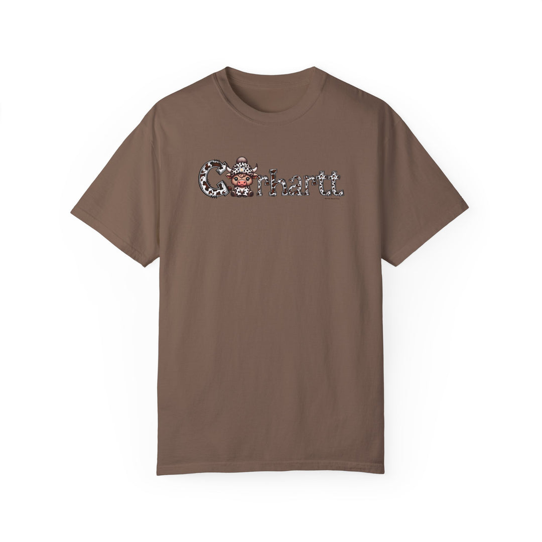 A cozy Cowhartt Cow Tee in brown, featuring a cartoon cow design on a soft ring-spun cotton t-shirt. Relaxed fit, durable double-needle stitching, and no side-seams for comfort and style.