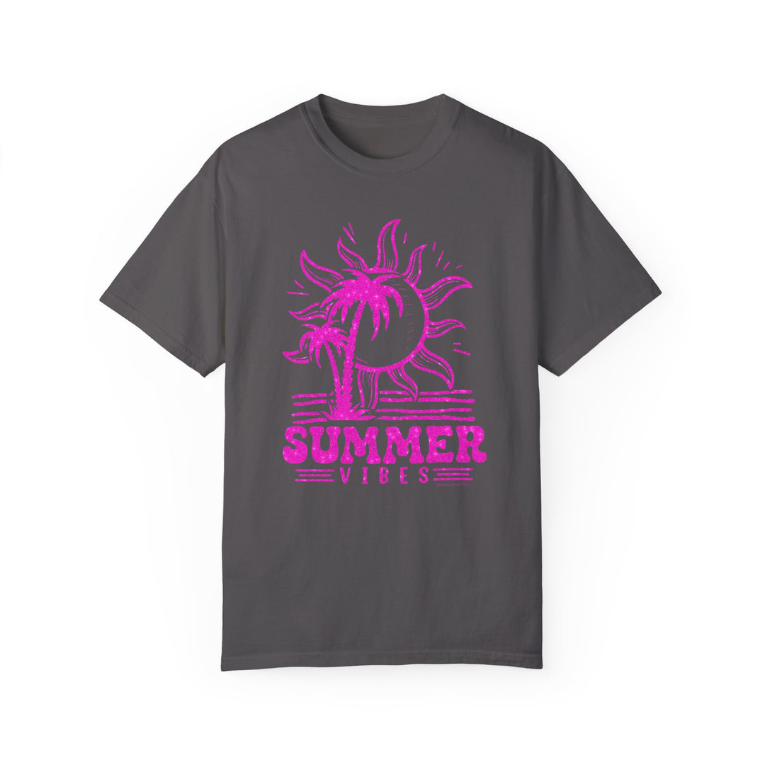 A grey Summer Vibes Tee with a pink sun and palm trees design. 100% ring-spun cotton, garment-dyed for coziness, relaxed fit, durable double-needle stitching, and seamless sides for a tubular shape.