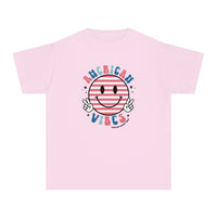 American Vibes Youth Tee: A pink t-shirt with a smiley face design, perfect for active kids. 100% combed ringspun cotton, soft-washed, and garment-dyed for comfort. Classic fit for all-day wear.
