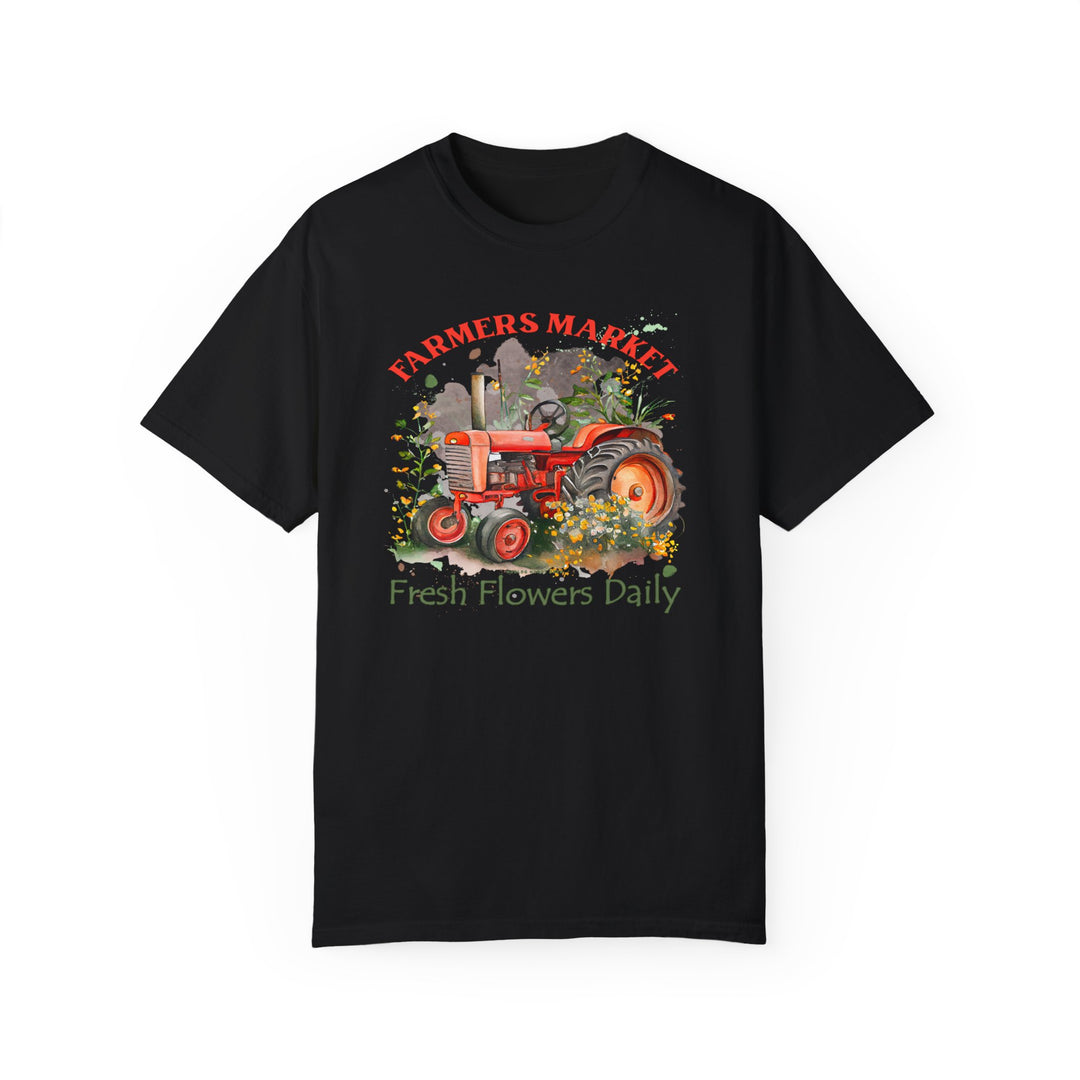 A black tee featuring a tractor and flowers, the Fresh Flowers Tee from Worlds Worst Tees. Made of 100% ring-spun cotton with a relaxed fit for daily comfort. Durable double-needle stitching and seamless design.