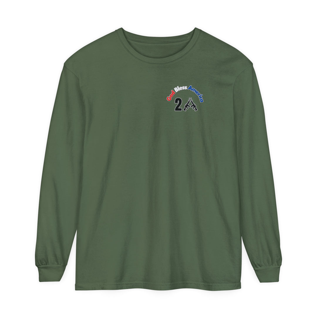 A green long-sleeve tee featuring a logo with text and guns, embodying the God Bless America 2A design. Made of 100% ring-spun cotton, garment-dyed, with a relaxed fit for comfort. Classic Fit, medium fabric.