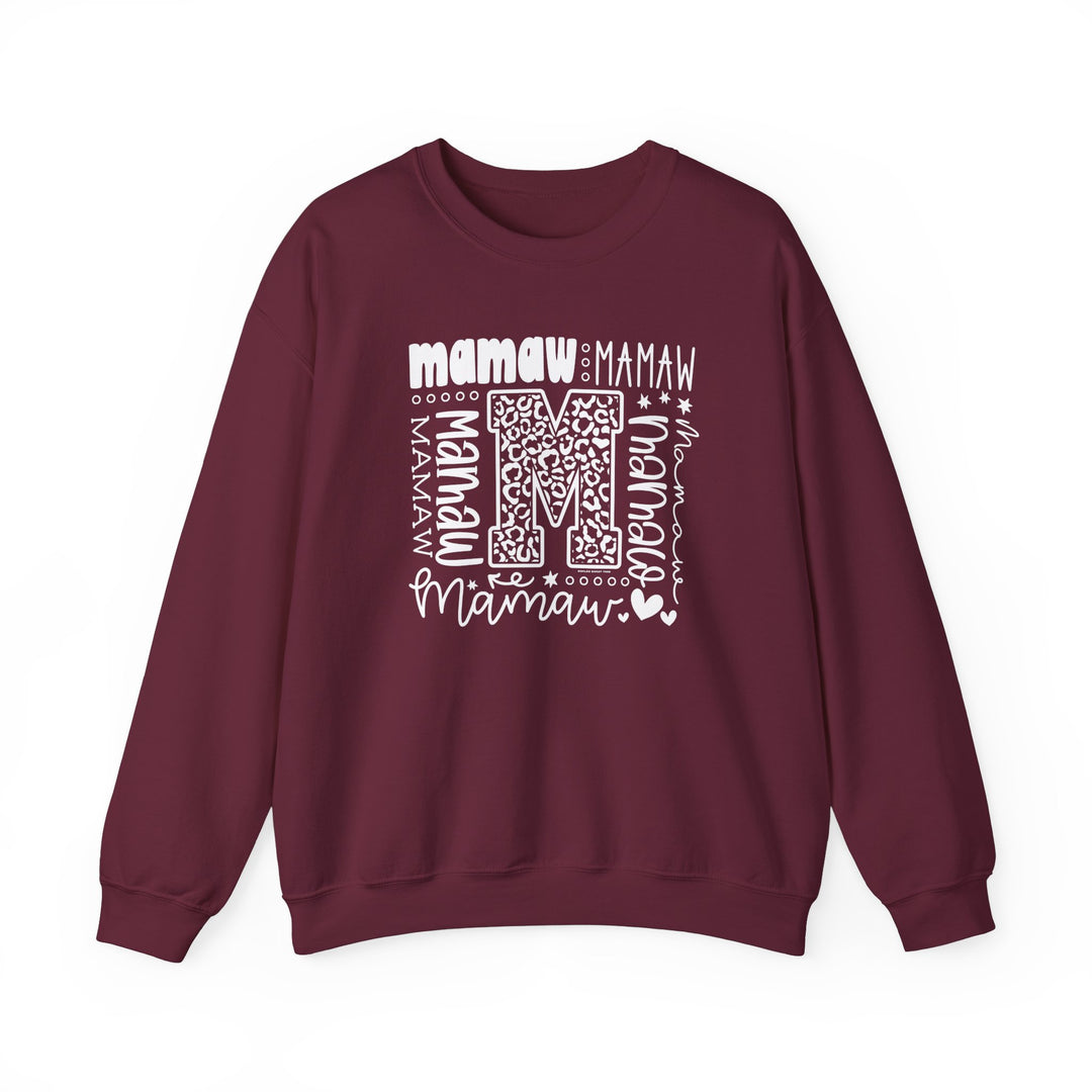 A unisex Mamaw Crew heavy blend sweatshirt in maroon with white letters. Features ribbed knit collar, no itchy side seams, and durable double-needle stitching. Made from 50% cotton, 50% polyester fabric blend.