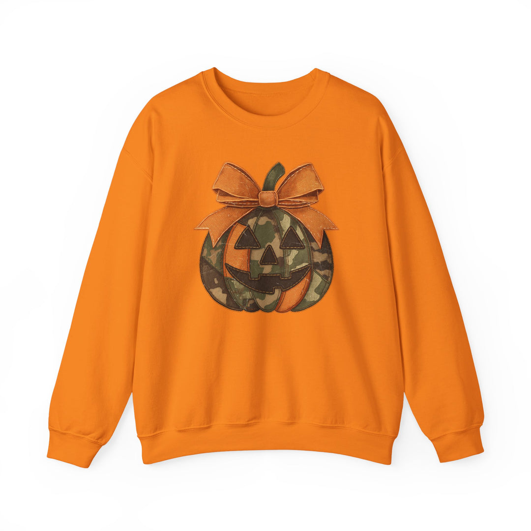 Jackie O Crew: Orange sweatshirt with camo-patterned jack-o-lantern graphic topped with an orange bow, ideal for cozy, playful Halloween style.