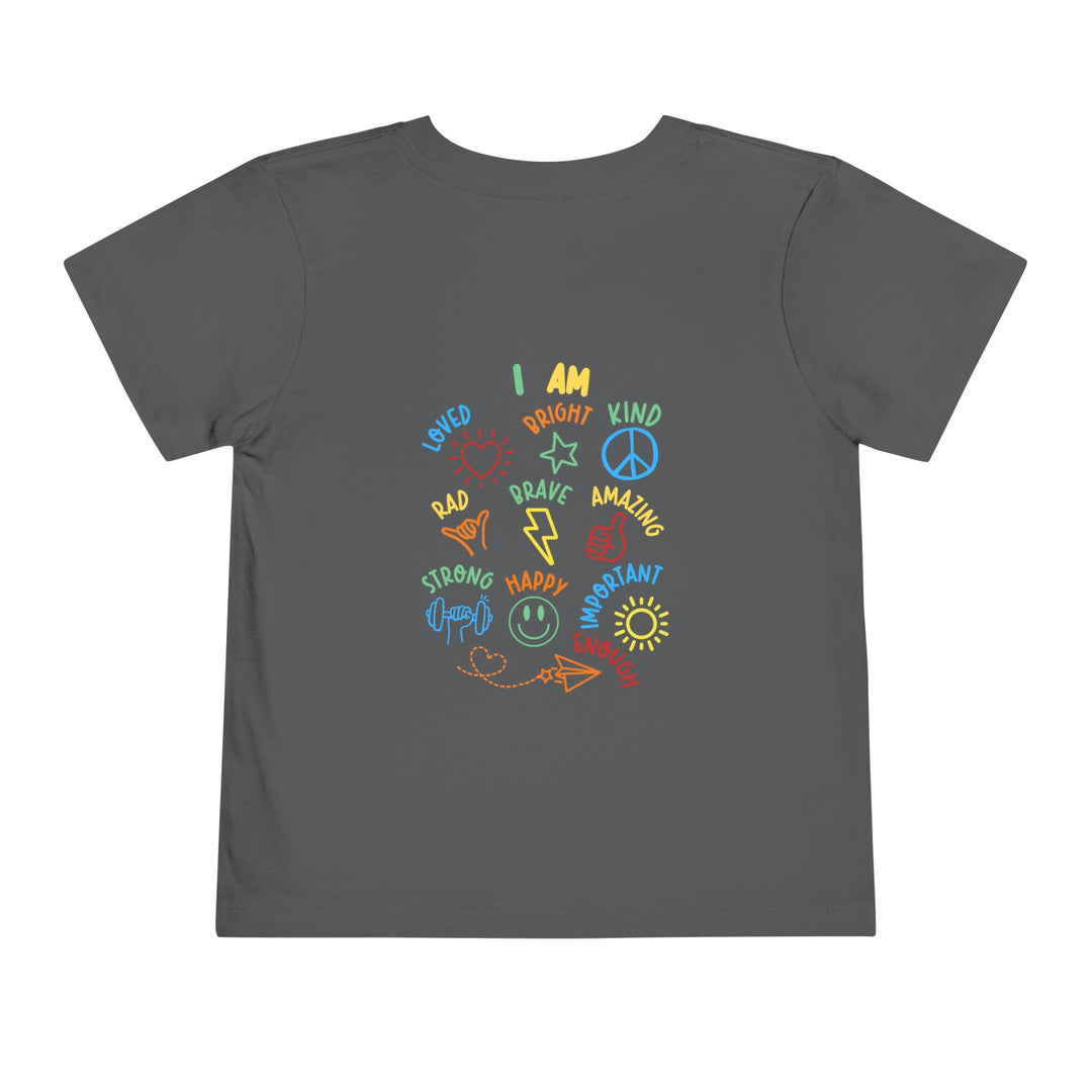 I AM Toddler Tee: Dark-gray shirt featuring colorful doodles and affirmations like LOVED, BRAVE, and HAPPY, with matching icons, made from soft, comfortable cotton.