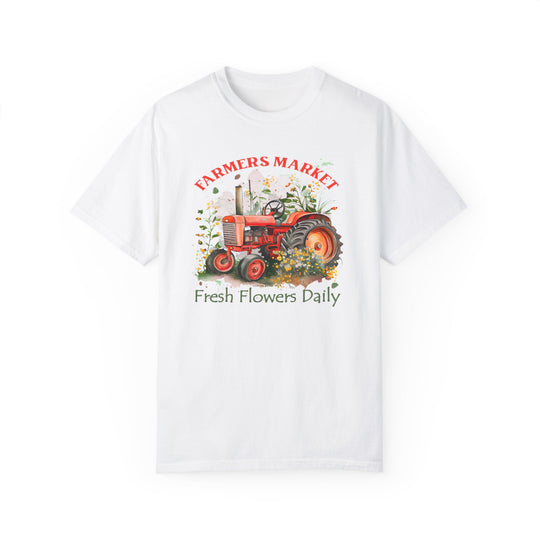 A white t-shirt featuring a tractor and plants, embodying the Fresh Flowers Tee style from Worlds Worst Tees. Made of 100% ring-spun cotton for comfort and durability, with a relaxed fit and double-needle stitching.