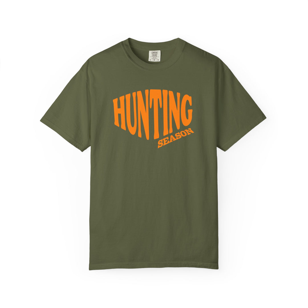 Olive-green Hunting Season tee with bold orange print, featuring a relaxed fit and durable double-needle stitching, perfect for casual wear.