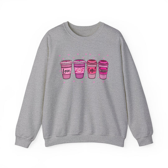 Unisex XOXO Coffee Crew sweatshirt, grey with pink coffee cups. Heavy blend fabric, ribbed knit collar, no itchy seams. Sizes S-5XL. Ideal comfort for any occasion.